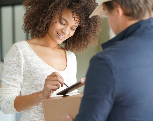 woman signing delivery package